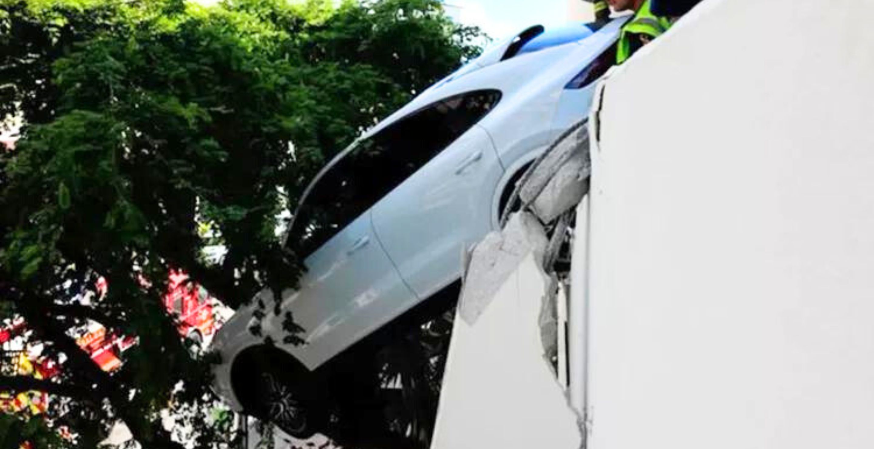 Woman Crashes Porsche Through Parking Garage On Third Floor And Onto Tree