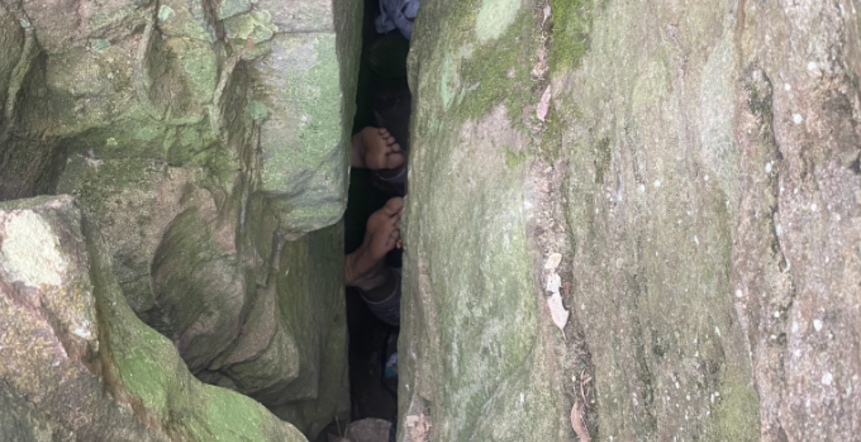 woman stuck in rocks when trying to save phone