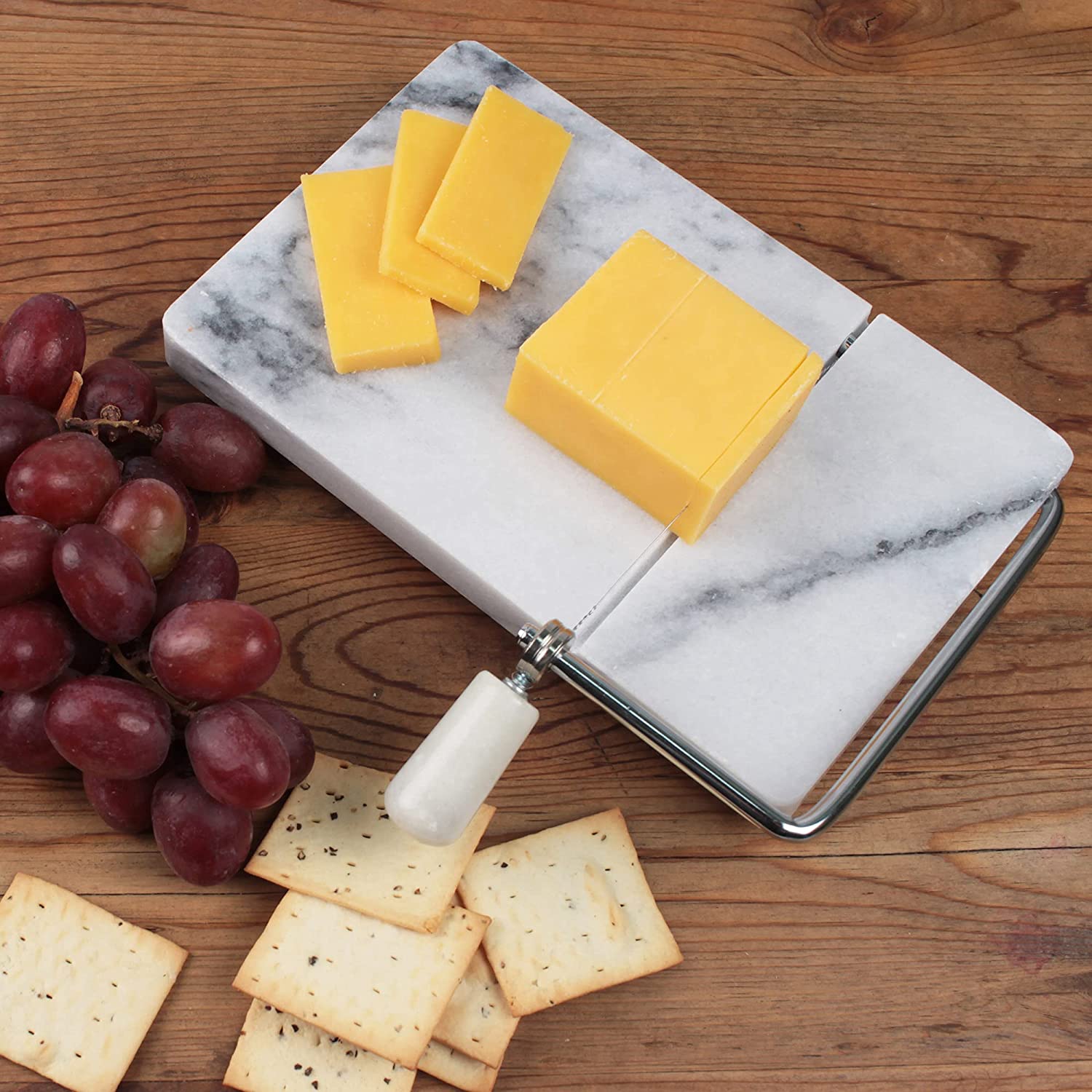 https://www.wideopencountry.com/wp-content/uploads/sites/4/eats/2021/07/RSVP-International-White-Marble-Cheese-Slicer-Cutting-Board-522-x-822-Cut-Cheeses-Meats-Other-Appetizers-Each-Piece-Unique-in-Marble-Coloring-Stainless-Steel-Wire-Cheese-Slicer-.jpg?resize=1500%2C1500